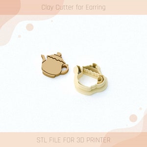 May include: A 3D printed clay cutter in the shape of a teapot. The cutter is beige and has a detailed design. The image includes the text "Clay Cutter for Earring" and "STL FILE FOR 3D PRINTER".