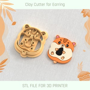 May include: A 3D printed clay cutter for earrings shaped like a hamster holding a nut. The cutter is made of brown plastic and has a detailed design. STL FILE FOR 3D PRINTER.