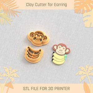 Pode incluir: Dois cortadores de argila impressos em 3D para brincos, um com um rosto de macaco e o outro com um macaco segurando bananas. Arquivo STL para impressora 3D.