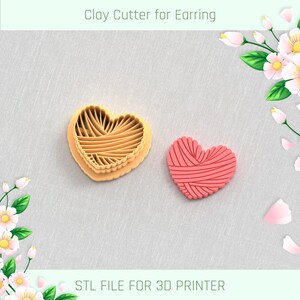 May include: A 3D printed clay cutter for earrings in the shape of a heart with a yarn design. The cutter is orange and the sample earring is pink. STL FILE FOR 3D PRINTER.