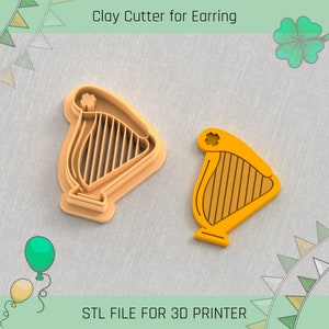 May include: A 3D printed clay cutter shaped like a harp with a shamrock on top. The cutter is orange and has a detailed design. STL FILE FOR 3D PRINTER.
