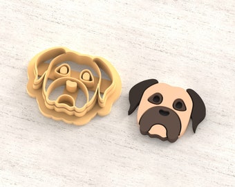 May include: A 3D printed clay cutter for earrings in the shape of a dog's head. The cutter is beige and brown and is shown on a light wood surface. STL FILE FOR 3D PRINTER.