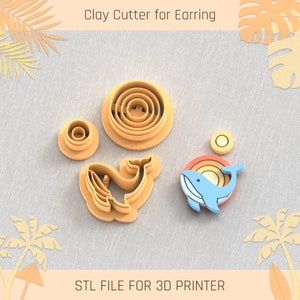 May include: A set of five clay cutters for earrings, including a whale, a sun, and three circles. The cutters are made for 3D printing and are in orange and blue.