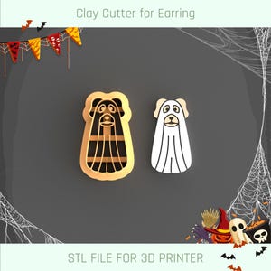 May include: Two 3D printed cookie cutters for making Halloween-themed cookies. One cutter is shaped like a ghost with a simple face, and the other is shaped like a dog wearing a striped scarf. The text "STL FILE FOR 3D PRINTER" is printed below the cutters.
