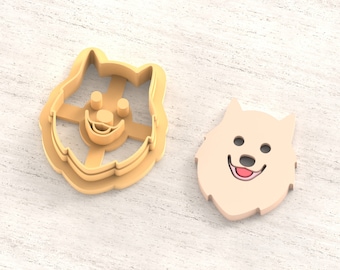 May include: A 3D printed clay cutter for earrings, shaped like a dog's head. The cutter is beige and has a smiling face. The text "Clay Cutter for Earring" and "STL FILE FOR 3D PRINTER" are visible in the image.