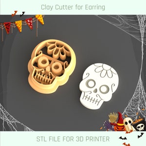May include: A 3D printable STL file for a sugar skull cookie cutter. The cutter is designed for making sugar skull earrings. The image shows two sugar skull cookie cutters, one in white and one in brown.