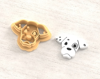 May include: A 3D printed clay cutter for earrings in the shape of a Dalmatian dog head. The cutter is beige and the printed model is white. The text "Clay Cutter for Earring" and "STL FILE FOR 3D PRINTER" are visible in the image.
