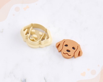 May include: Two dog head clay cutters for earrings. One cutter is beige and the other is brown. The cutters are on a white surface. STL FILE FOR 3D PRINTER.