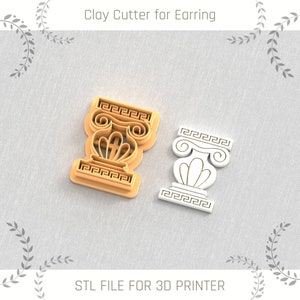 May include: Two 3D printed clay cutters for earrings, one in gold and one in white, shaped like a Greek column with a decorative top and base.