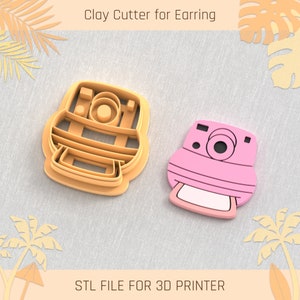 May include: Two 3D printed clay cutters shaped like vintage cameras. The cutters are orange and pink. The text "STL FILE FOR 3D PRINTER" is at the bottom of the image.