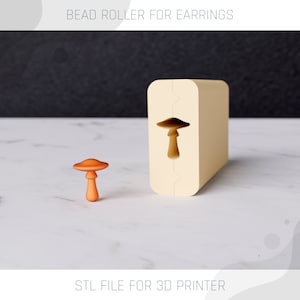 May include: A 3D printed mold for making mushroom-shaped earrings. The mold is beige and has a mushroom-shaped cutout. A small orange mushroom-shaped earring is shown next to the mold. STL file for 3D printer.