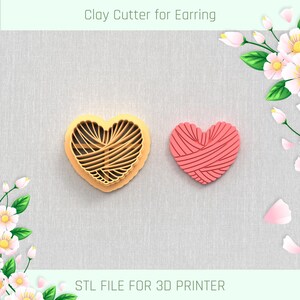 May include: A 3D printed clay cutter for earrings in the shape of a heart with a woven pattern. The cutter is orange and the background is a light gray fabric. The text "Clay Cutter for Earring" and "STL FILE FOR 3D PRINTER" are visible in the image.
