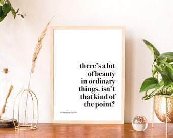 May include: A framed print with a white background and black text that reads "there's a lot of beauty in ordinary things. isn't that kind of the point?"  The text is attributed to "PAM BEESLY HALPERT".