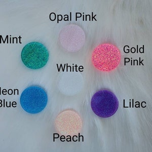 May include: Assortment of 10 round phone grips with glitter embedded in the resin. Colors include: opal pink, mint, white, gold pink, neon blue, lilac, and peach.