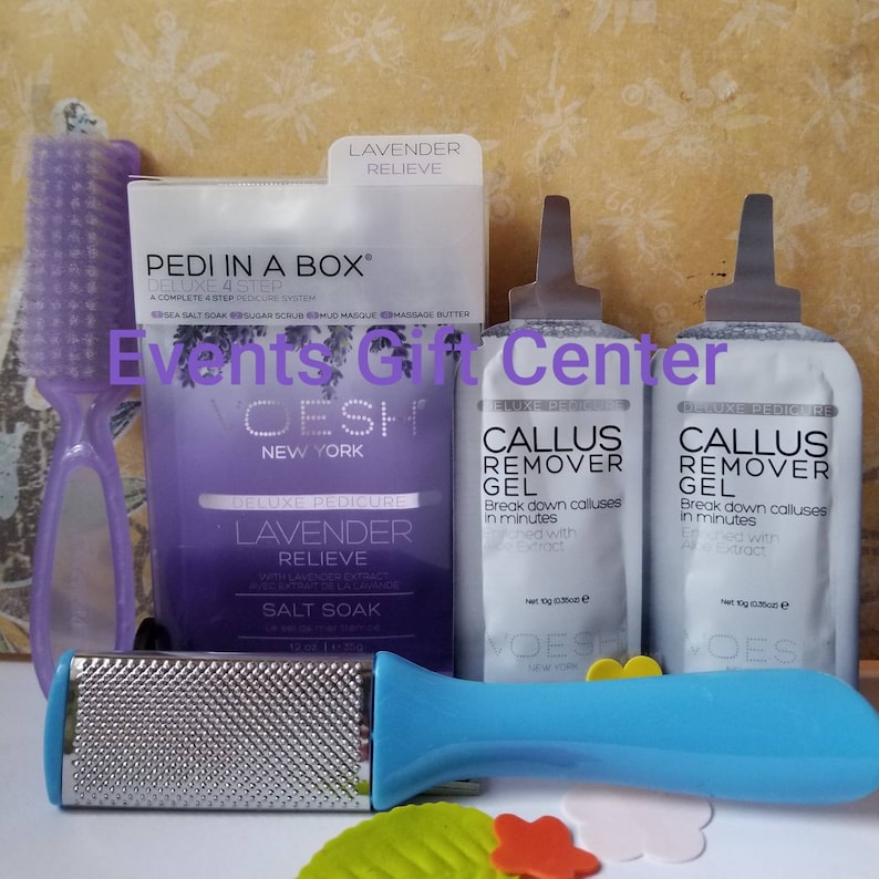 May include: A lavender-scented pedicure kit with a foot file, brush, and two packets of callus remover gel. The kit is labeled "Pedi in a Box Deluxe 4 Step" and "Lavender Relieve".