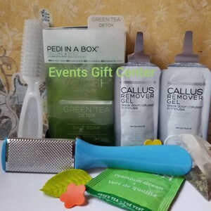 May include: A green tea detox foot care kit with a foot file, brush, salt soak, and callus remover gel packets. The kit includes the text "Green Tea Detox" and "Pedi in a Box".