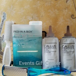 May include: A blue and white pedicure kit with a foot file, two tubes of callus remover gel, and a box of sea salt soak. The box has the text "PEDI IN A BOX" and "OCEAN REFRESH".