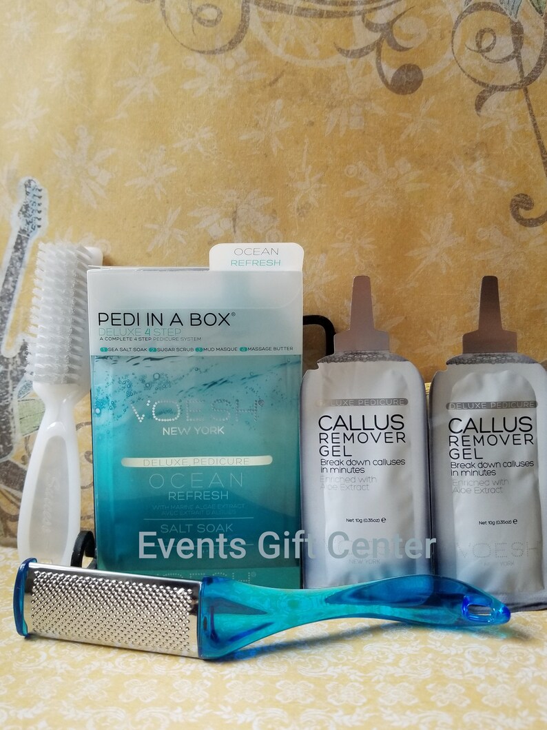 May include: A blue and white pedicure kit with a foot file, two tubes of callus remover gel, and a box of sea salt soak. The box has the text "PEDI IN A BOX" and "OCEAN REFRESH".