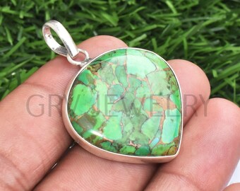 May include: A silver pendant featuring a green turquoise stone in a heart shape.
