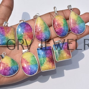 May include: Nine rainbow crystal pendants with silver settings. The pendants are in various shapes, including teardrop, oval, and square.