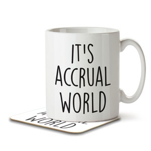 May include: White ceramic mug with a black inscription that reads "It's Accrual World". The mug is sitting on a coaster with the same inscription.