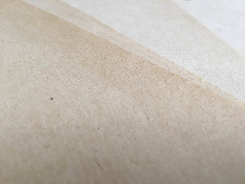 May include: Close-up of a light brown textured paper surface.