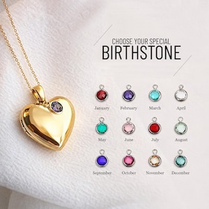 May include: A gold heart-shaped locket necklace with a purple gemstone. The image shows a selection of birthstone charms, each labelled with a month. The text "CHOOSE YOUR SPECIAL BIRTHSTONE" is also visible.