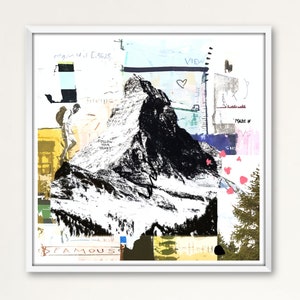May include: Square framed art print featuring a black and white mountain illustration with a hiker. The artwork includes text fragments and colorful abstract elements. The words "FAMOUS", "VIEW", and "FOLLOW YOUR HEART" are visible.