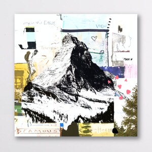 May include: Abstract art print featuring a black and white mountain illustration with the words "FAMOUS" and "FOLLOW YOUR HEART". The artwork includes a hiker, a heart, and the word "VIEW". The background has a collage of colors.