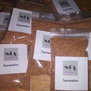 May include: Multiple clear plastic bags filled with a brown granular substance. Each bag features a white label with the word "Separation" and a graphic of three birds on a wire. The brand name "3 Pagan Ravens" is also on the label.