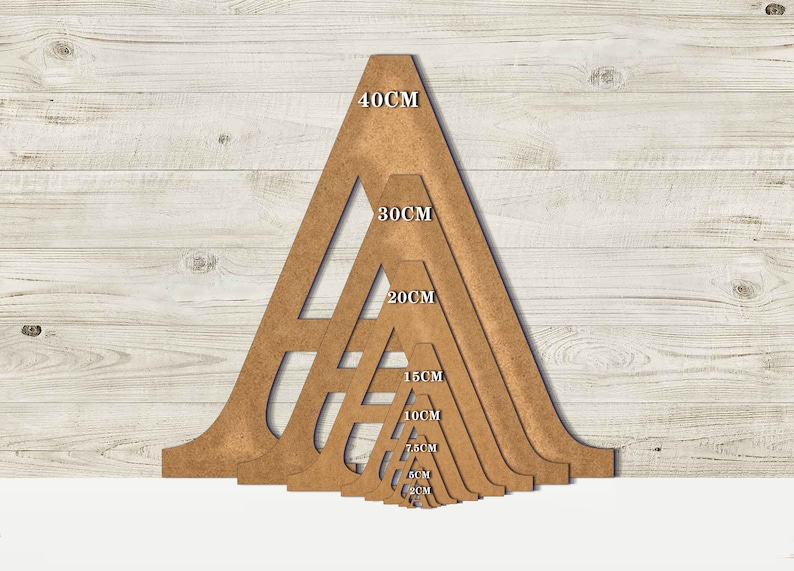 May include: A set of seven wooden triangle stencils in various sizes, ranging from 5 cm to 40 cm. The stencils are arranged in a pyramid shape, with the largest stencil at the top and the smallest stencil at the bottom.