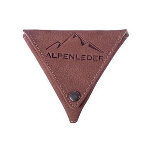 Könnte beinhalten: Eine braune Ledermünzbörse mit dreieckiger Form und einem Druckknopfverschluss. Die Börse hat ein Bergketten-Design und den Text "ALPENLEDER" auf der Vorderseite geprägt.