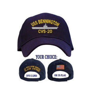 May include: A navy blue baseball cap with the text "USS BENNINGTON CVS-20" embroidered on the front. The back of the cap has two options for personalization: a US flag or a name and title with up to two lines of text.