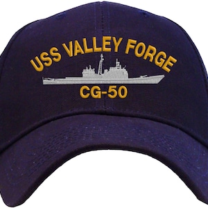 May include: A navy blue baseball cap with an embroidered white ship and the text "USS VALLEY FORGE CG-50" in yellow.