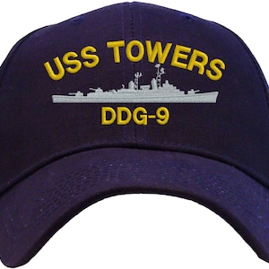 May include: A navy blue baseball cap with an embroidered image of a ship and the text "USS TOWERS DDG-9" in yellow.