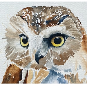 May include: A watercolor painting of an owl's face. The owl has brown and white feathers, with yellow eyes and a sharp beak. The background is a light gray.