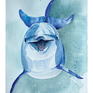 May include: A watercolor painting of a blue dolphin with a light blue background. The dolphin is smiling with its mouth open and its flippers are raised.