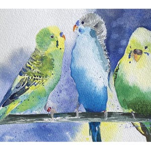 May include: Watercolor painting of three parakeets perched on a branch. The birds feature vibrant colors: green, yellow, and blue. The background is a blend of blue and white, creating a soft, artistic effect. The parakeets are facing each other.
