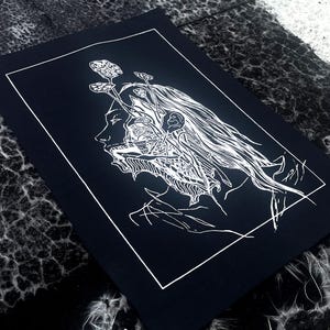 May include: A monochrome art print depicting a detailed illustration of a person's profile. The artwork shows the person's head with intricate internal details and plant-like elements emerging from the head. The print is set against a black background.