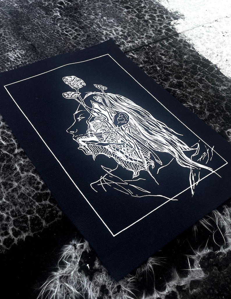 May include: A monochrome art print depicting a detailed illustration of a person's profile. The artwork shows the person's head with intricate internal details and plant-like elements emerging from the head. The print is set against a black background.