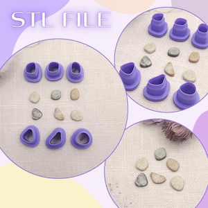 May include: The image displays a collection of purple, ring-shaped tools and small, irregularly shaped stones. The text "STL FILE" is visible at the top. The tools appear to be for crafting or creating, and the stones add a natural element to the composition.
