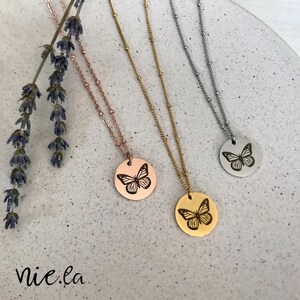 Peut inclure: Trois colliers délicats avec un pendentif rond orné d'un motif de papillon. Les colliers sont disponibles en or rose, or et argent.