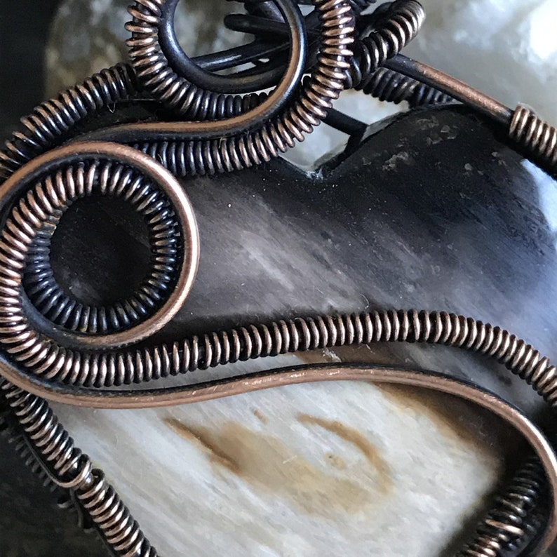 Indonesian Fossilized Palm Root Heart Pendant wrapped with a Sweeping Curve of Coiled Antiqued Copper