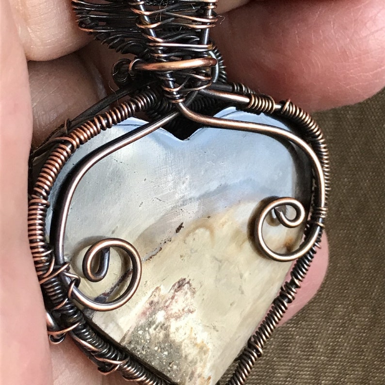Indonesian Fossilized Palm Root Heart Pendant wrapped with a Sweeping Curve of Coiled Antiqued Copper