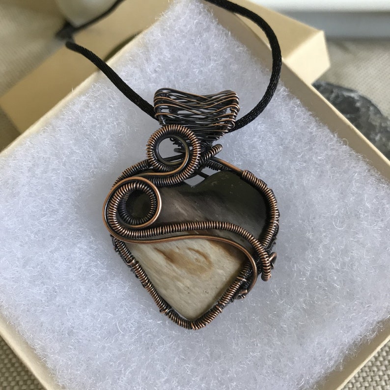 Indonesian Fossilized Palm Root Heart Pendant wrapped with a Sweeping Curve of Coiled Antiqued Copper