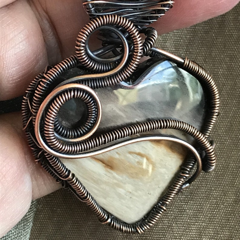 Indonesian Fossilized Palm Root Heart Pendant wrapped with a Sweeping Curve of Coiled Antiqued Copper