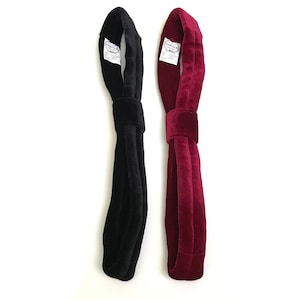 May include: Two velvet headbands, one black and one burgundy. Both headbands have a small white label with the text "CIRCUS" on them.