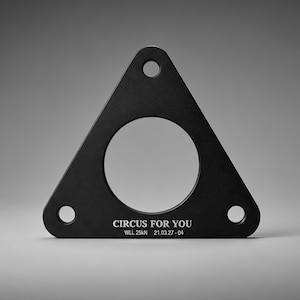 May include: Black metal triangular bracket with a large central circular opening and three smaller holes. The text "CIRCUS FOR YOU" and other markings are printed on the surface.
