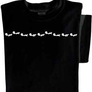 May include: Black t-shirt with a row of white silhouettes of foxes across the chest.