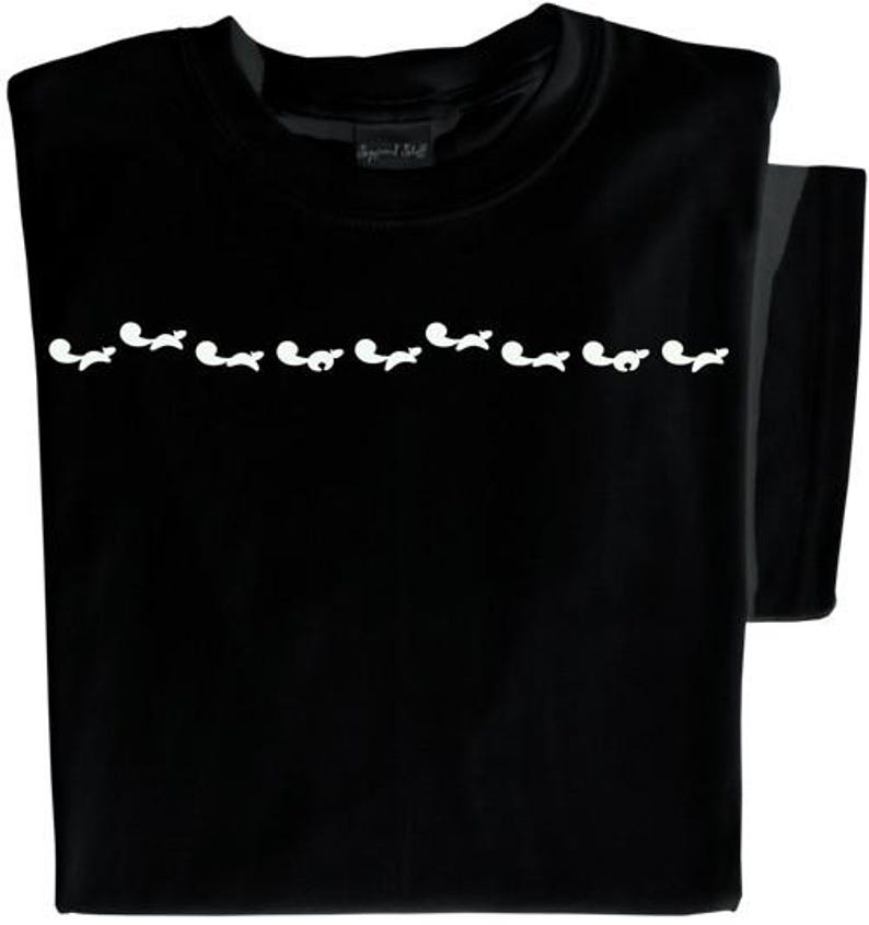 May include: Black t-shirt with a row of white silhouettes of foxes across the chest.